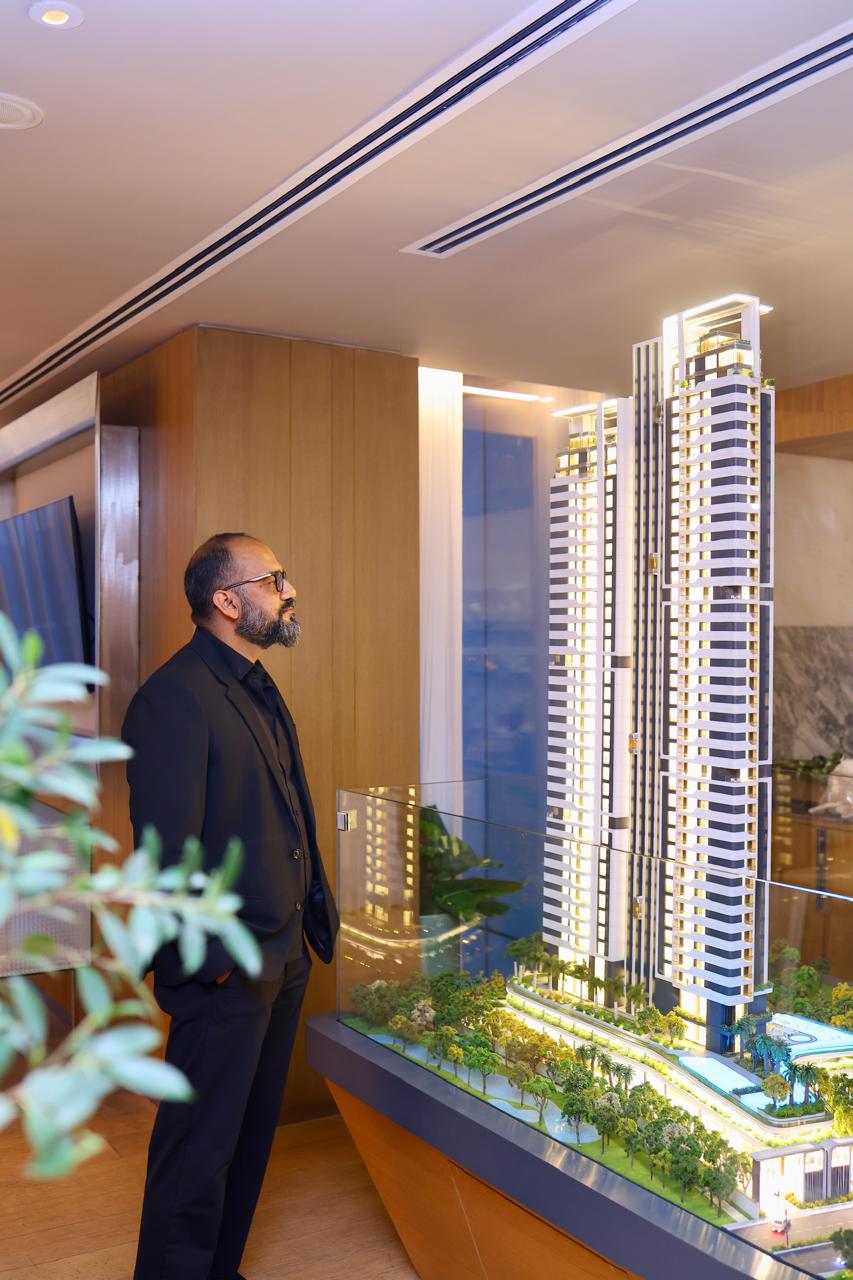 Vijay Sharma reviewing a luxury real-estate model